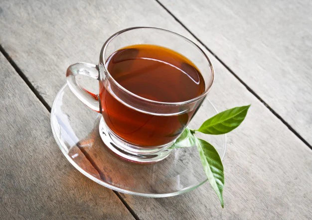 Cup of green tea and leave kept in plate | green tea for weight loss