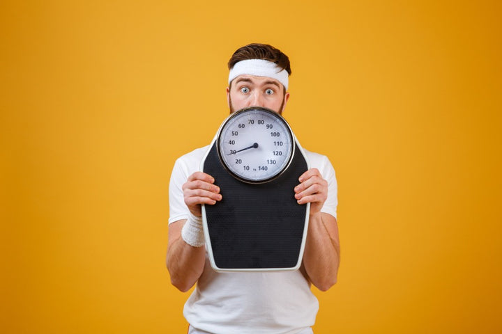 man with a weighing scale | How Does Fat Leave Your Body When You Lose Weight? | weight loss