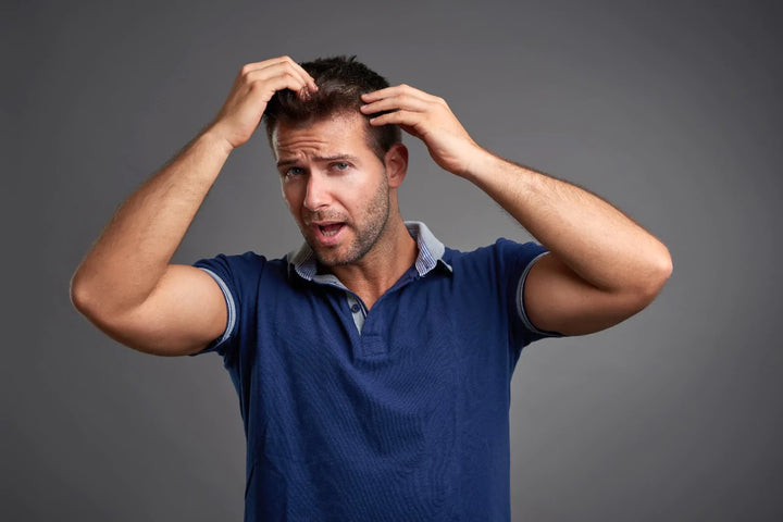 Man styling his hair with his hands | how to increase melanin in hair