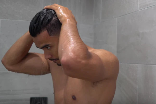 man showering | hard water shampoo