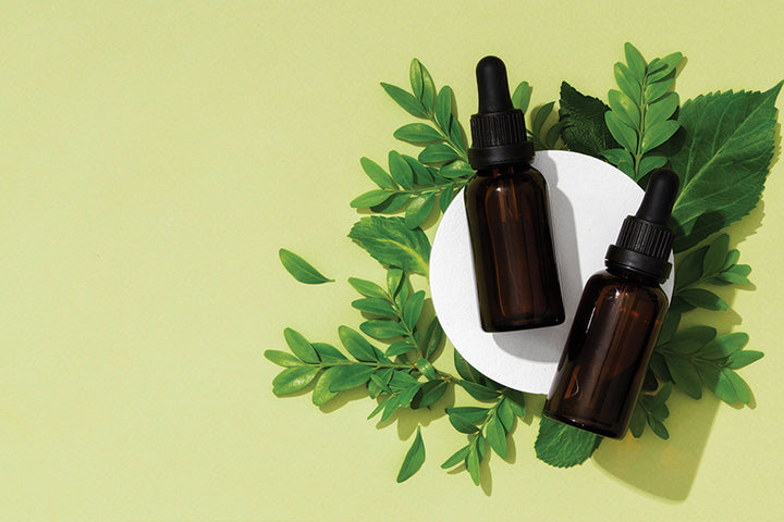 Bottles of oil and neem leaves | neem oil