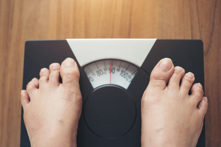 a person standing on weight machine