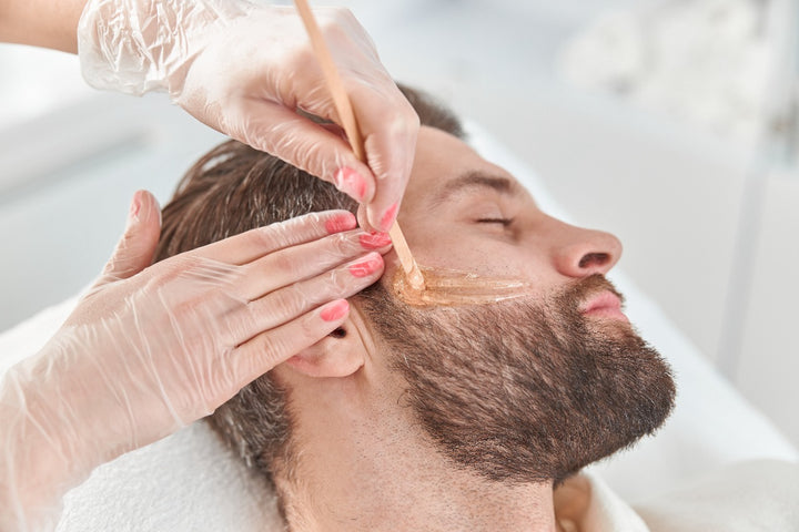 a man using face wax