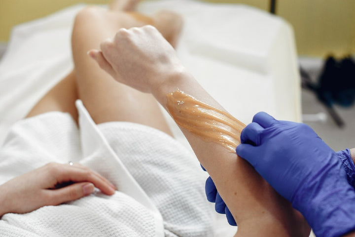 a woman getting her hands waxed